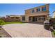 Expansive backyard featuring artificial turf, a brick patio, and seamless flow from indoor living spaces at 9764 E Radioactive Dr, Mesa, AZ 85212