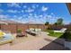 Inviting backyard featuring a brick paver patio, artificial turf, and comfortable outdoor seating under a bright sky at 9764 E Radioactive Dr, Mesa, AZ 85212