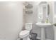 Powder bathroom with pedestal sink, modern lighting, and decorative shelving at 9764 E Radioactive Dr, Mesa, AZ 85212