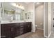 Bathroom featuring espresso cabinets, double sinks, white countertops, and an enclosed toilet at 9764 E Radioactive Dr, Mesa, AZ 85212