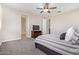 Bedroom features carpet, ceiling fan and a chest with a television, creating a comfortable space at 9764 E Radioactive Dr, Mesa, AZ 85212