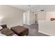 Comfortable bonus room, featuring a plush sectional, neutral paint, and cozy carpet at 9764 E Radioactive Dr, Mesa, AZ 85212