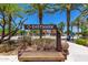 Eastmark community entrance featuring a bench, signage, palm trees and attractive landscaping at 9764 E Radioactive Dr, Mesa, AZ 85212