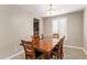 Dining room with wood table, seating for six, and a window that provides lots of natural light at 9764 E Radioactive Dr, Mesa, AZ 85212