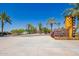 Eastmark's Home Finding Center entrance with palm trees and desert landscaping on a sunny day at 9764 E Radioactive Dr, Mesa, AZ 85212