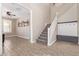 Welcoming entryway featuring a staircase, a coat rack, and wood-look tile flooring at 9764 E Radioactive Dr, Mesa, AZ 85212