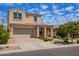 Charming two-story home with a tile roof, manicured landscaping, and an attached two-car garage at 9764 E Radioactive Dr, Mesa, AZ 85212