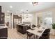 Modern kitchen showcasing an island, stainless steel appliances, and an adjacent dining area at 9764 E Radioactive Dr, Mesa, AZ 85212