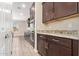 A modern kitchen featuring stainless steel appliances, granite countertops, and dark wood cabinetry at 9764 E Radioactive Dr, Mesa, AZ 85212