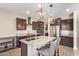 Kitchen with island, stainless steel appliances, granite counters, and dark cabinets at 9764 E Radioactive Dr, Mesa, AZ 85212