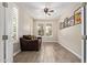 Cozy living room with tile floors, plantation shutters, a ceiling fan, and natural light at 9764 E Radioactive Dr, Mesa, AZ 85212