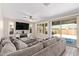 Comfortable living room with tile flooring, plantation shutters, and a large couch at 9764 E Radioactive Dr, Mesa, AZ 85212