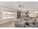 Comfortable living room with tile flooring, plantation shutters, and a view to the kitchen at 9764 E Radioactive Dr, Mesa, AZ 85212