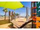 Modern playground with diverse climbing features and sunshade, offering a fun and safe environment at 9764 E Radioactive Dr, Mesa, AZ 85212
