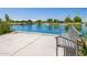 Scenic view of the community pond from a relaxing bench area, showcasing the tranquil environment at 9764 E Radioactive Dr, Mesa, AZ 85212