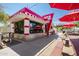 Charming community restaurant featuring red umbrellas, a retro design, and inviting outdoor seating at 9764 E Radioactive Dr, Mesa, AZ 85212