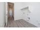Functional laundry room with a utility sink and shelving for storage at 9775 S 36Th Ln, Laveen, AZ 85339