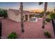 Beautiful backyard featuring a covered patio, swing, and desert landscaping at 12928 W Santa Ynez Dr, Sun City West, AZ 85375