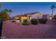 This backyard has a covered patio, lush desert landscaping, and offers privacy and tranquility at 12928 W Santa Ynez Dr, Sun City West, AZ 85375