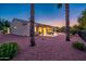 The backyard provides a tranquil retreat with a covered patio, swing, desert landscaping, and mature trees at 12928 W Santa Ynez Dr, Sun City West, AZ 85375