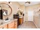 Well-lit bathroom with double sinks, granite countertops, and decorative mirrors at 12928 W Santa Ynez Dr, Sun City West, AZ 85375
