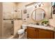 Modern bathroom featuring granite countertops, a wood cabinet, a tiled stand-up shower, and a mirror at 12928 W Santa Ynez Dr, Sun City West, AZ 85375