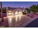 Attractive single-story home featuring an expansive driveway, three-car garage, and desert landscaping at 12928 W Santa Ynez Dr, Sun City West, AZ 85375