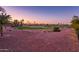 The property overlooks a scenic golf course with mature trees and manicured greens at sunset at 12928 W Santa Ynez Dr, Sun City West, AZ 85375