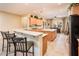 Bright, open kitchen features a large island, breakfast bar, and stainless steel appliances at 12928 W Santa Ynez Dr, Sun City West, AZ 85375