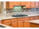Modern kitchen featuring stainless steel appliances, a stylish backsplash, and ample counter space at 12928 W Santa Ynez Dr, Sun City West, AZ 85375