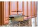 An eye-level picture shows the wooden cabinetry with a range hood at 12928 W Santa Ynez Dr, Sun City West, AZ 85375