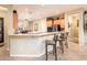 Open kitchen with bar seating overlooking the dining area at 12928 W Santa Ynez Dr, Sun City West, AZ 85375