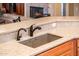 Modern kitchen sink with updated fixtures and a stylish countertop at 12928 W Santa Ynez Dr, Sun City West, AZ 85375