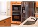 An updated kitchen showcases stainless steel appliances and stone countertops at 12928 W Santa Ynez Dr, Sun City West, AZ 85375