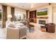 Comfortable living room with a fireplace, and sliding glass door to the backyard at 12928 W Santa Ynez Dr, Sun City West, AZ 85375