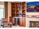 Stylish living room with custom built-ins, a cozy recliner, and a modern TV at 12928 W Santa Ynez Dr, Sun City West, AZ 85375