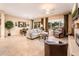 Open floorplan living room with a sliding glass door to the backyard and a fireplace at 12928 W Santa Ynez Dr, Sun City West, AZ 85375
