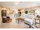 Open concept living room with bar seating, tile floors and view into the kitchen at 12928 W Santa Ynez Dr, Sun City West, AZ 85375