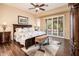 Serene main bedroom boasts wood floors, ceiling fan, and access to outdoor patio at 12928 W Santa Ynez Dr, Sun City West, AZ 85375