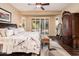 Stylish main bedroom features a decorative rug, ceiling fan, and ample natural light at 12928 W Santa Ynez Dr, Sun City West, AZ 85375