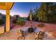 Inviting patio with seating, fire pit, and views of the lush landscaping and golf course at 12928 W Santa Ynez Dr, Sun City West, AZ 85375