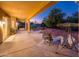 Covered patio with comfortable seating, desert landscaping, and ample space for outdoor entertainment at 12928 W Santa Ynez Dr, Sun City West, AZ 85375
