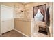 Nicely tiled stand-up shower with a bench and window at 12928 W Santa Ynez Dr, Sun City West, AZ 85375