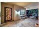 Cozy side entrance with a secure door, comfortable seating, and ambient lighting at 12928 W Santa Ynez Dr, Sun City West, AZ 85375