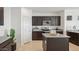 Modern kitchen with dark cabinetry, stainless steel appliances, granite countertops, and an island at 1324 S Mullberry St, Florence, AZ 85132