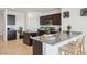 Well-appointed kitchen with dark cabinetry, stainless steel appliances, a central island, and barstool seating at 1324 S Mullberry St, Florence, AZ 85132