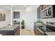 Modern kitchen featuring dark cabinets, stainless steel appliances, and a functional island with breakfast bar at 1324 S Mullberry St, Florence, AZ 85132