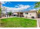 Spacious backyard with a covered patio, built in outdoor kitchen and relaxing patio and yard at 13359 W Post Dr, Surprise, AZ 85374