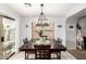Dining area featuring a modern chandelier, and views of outdoor space through sliding glass door at 13359 W Post Dr, Surprise, AZ 85374