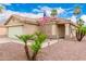 Beautiful one-story home with mature landscaping and a charming front entryway, featuring a US flag at 13359 W Post Dr, Surprise, AZ 85374